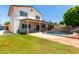 Expansive backyard featuring lush lawn and a sparkling pool with covered patio at 2547 W Naranja Ave, Mesa, AZ 85202