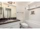 Bright bathroom featuring granite countertop vanity, tile flooring and shower over tub combo at 2547 W Naranja Ave, Mesa, AZ 85202