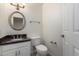 Cozy bathroom featuring a granite countertop vanity, oval mirror and tile flooring at 2547 W Naranja Ave, Mesa, AZ 85202