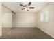 Bedroom features neutral carpet, ceiling fan, large closet with mirror doors, and window with plantation shutters at 2547 W Naranja Ave, Mesa, AZ 85202