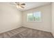 A neutral bedroom featuring bright windows, plush carpet and a modern ceiling fan at 2547 W Naranja Ave, Mesa, AZ 85202