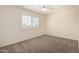 A carpeted bedroom with window and plantation shutters, ceiling fan and a neutral color palette at 2547 W Naranja Ave, Mesa, AZ 85202