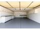 Spacious garage featuring painted epoxy flooring, work benches and storage cabinets at 2547 W Naranja Ave, Mesa, AZ 85202