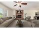 Inviting living room with a classic brick fireplace and comfortable seating arrangement at 2547 W Naranja Ave, Mesa, AZ 85202