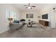 Cozy living room features a comfortable sectional, stylish rug, and abundant natural light at 2547 W Naranja Ave, Mesa, AZ 85202