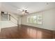 Spacious living room featuring hardwood floors, a ceiling fan, and large windows with plantation shutters at 2547 W Naranja Ave, Mesa, AZ 85202