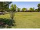 Community park with a disc golf basket, playground, expansive grassy area, and picnic area at 2547 W Naranja Ave, Mesa, AZ 85202
