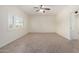 Bright and airy room featuring neutral paint, ceiling fan, tile floors, baseboards, plus a view to another room at 2547 W Naranja Ave, Mesa, AZ 85202
