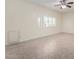 Bright empty room featuring neutral paint, tile floors, baseboards and a ceiling fan plus a view to the exterior at 2547 W Naranja Ave, Mesa, AZ 85202