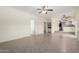 Spacious room showcasing tile floors, neutral paint, baseboards, ceiling fan, and access to other areas of the home at 2547 W Naranja Ave, Mesa, AZ 85202