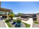 Serene backyard with hot tub, lounge area, mature landscaping, and travertine patio perfect for entertaining at 26314 N 103Rd Dr, Peoria, AZ 85383