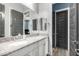Bathroom featuring double sinks, granite countertops, and stylish finishes at 26314 N 103Rd Dr, Peoria, AZ 85383