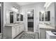 Well lit bathroom featuring double vanity with granite, mirrors, and tile backsplash at 26314 N 103Rd Dr, Peoria, AZ 85383