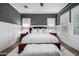 A spacious bedroom with hardwood floors, dark accent wall, and plantation shutters at 26314 N 103Rd Dr, Peoria, AZ 85383