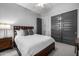 Bedroom with queen bed, a ceiling fan, wood floor, dark doors, and lots of light at 26314 N 103Rd Dr, Peoria, AZ 85383