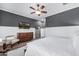 Bedroom features hardwood flooring, TV, and a sliding mirrored door to a closet at 26314 N 103Rd Dr, Peoria, AZ 85383