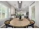 Well-lit dining room featuring a wood table with seating and a modern chandelier at 26314 N 103Rd Dr, Peoria, AZ 85383