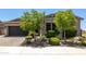Attractive single-story home with a well-maintained lawn, mature trees, and a convenient two-car garage at 26314 N 103Rd Dr, Peoria, AZ 85383