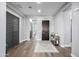 Entryway featuring hardwood floors, light grey walls, an area rug, and a dark-stained entry door at 26314 N 103Rd Dr, Peoria, AZ 85383
