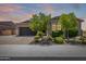 Charming single-story home with a two-car garage, desert landscaping and a paved driveway at 26314 N 103Rd Dr, Peoria, AZ 85383