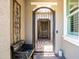 Charming gated front courtyard featuring a cozy bench, decorative metalwork, and inviting entrance at 26314 N 103Rd Dr, Peoria, AZ 85383