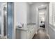 Hallway featuring a counter with storage, and a peek of the bedroom at 26314 N 103Rd Dr, Peoria, AZ 85383