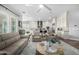 Open concept living room and kitchen with modern appliances and light, neutral tones at 26314 N 103Rd Dr, Peoria, AZ 85383