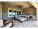 Relaxing covered patio with comfortable seating, outdoor kitchen, and panoramic views of the surroundings at 26314 N 103Rd Dr, Peoria, AZ 85383