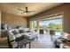 Inviting covered patio with ceiling fan, comfortable seating, and stunning views of backyard pool at 26314 N 103Rd Dr, Peoria, AZ 85383