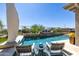 Backyard oasis features a sparkling pool, comfortable lounge chairs, and lush landscaping for relaxation at 26314 N 103Rd Dr, Peoria, AZ 85383