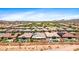 Expansive aerial view of a neighborhood boasting desert landscaping, pools, and tile-roofed homes at 30287 N 115Th Dr, Peoria, AZ 85383