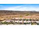 An aerial captures a residential area with single-Gathering homes, set against a backdrop of desert scenery at 30287 N 115Th Dr, Peoria, AZ 85383