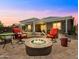 Backyard patio with pavers, chairs, and a fire pit for entertaining at 30287 N 115Th Dr, Peoria, AZ 85383