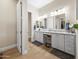 Well-lit bathroom featuring dual vanities, granite countertops, and ample storage space with neutral walls and floors at 30287 N 115Th Dr, Peoria, AZ 85383