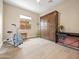 Neutral bedroom with Murphy bed, light hardwood flooring, and a bright window view at 30287 N 115Th Dr, Peoria, AZ 85383