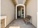 Charming entryway with a stone archway, a bench, and a decorative front door, offering a warm welcome at 30287 N 115Th Dr, Peoria, AZ 85383