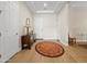 Bright foyer with a patterned circular rug, wood floors, and neutral walls creating a warm, welcoming atmosphere at 30287 N 115Th Dr, Peoria, AZ 85383