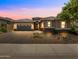 Beautiful single-Gathering home at sunset with a three-car garage and desert landscaping at 30287 N 115Th Dr, Peoria, AZ 85383