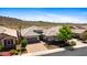 Inviting single-story home with desert landscaping, brick driveway, and a spacious two-car garage at 30287 N 115Th Dr, Peoria, AZ 85383