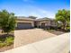 Beautiful single-Gathering home with a three-car garage and a brick driveway at 30287 N 115Th Dr, Peoria, AZ 85383