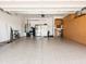 Spacious garage with epoxy flooring, built-in storage cabinets, and organized shelving at 30287 N 115Th Dr, Peoria, AZ 85383