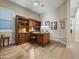 Cozy home office featuring hardwood floors, a built-in desk, and a computer at 30287 N 115Th Dr, Peoria, AZ 85383