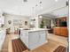 Bright kitchen with white cabinets, granite countertops, eat-in breakfast area, and open to the living room with scenic views at 30287 N 115Th Dr, Peoria, AZ 85383