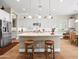 Bright kitchen with an island, pendant lights, stainless appliances, and white cabinets at 30287 N 115Th Dr, Peoria, AZ 85383