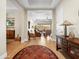 Inviting entryway flowing into a living space with hardwood floors, comfortable seating, and scenic views at 30287 N 115Th Dr, Peoria, AZ 85383