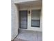 A closer shot of an apartment entrance featuring a security door and a window with blinds at 3119 W Cochise Dr # 148, Phoenix, AZ 85051