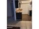 A clean, compact kitchen featuring dark wood cabinets, laminate countertops, and modern flooring at 3119 W Cochise Dr # 148, Phoenix, AZ 85051