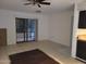 A basic living room with tile floors, a ceiling fan, and sliding doors to a patio at 3119 W Cochise Dr # 148, Phoenix, AZ 85051