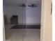 A partial view of a room featuring tile flooring, a modern ceiling fan, and an adjoining kitchen at 3119 W Cochise Dr # 148, Phoenix, AZ 85051