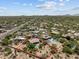 An aerial view of a property with a refreshing backyard pool, solar panels, and surrounding neighborhood at 31234 N 47Th Pl, Cave Creek, AZ 85331